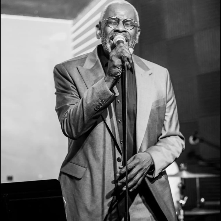 Jeff Robinson singing into a microphone